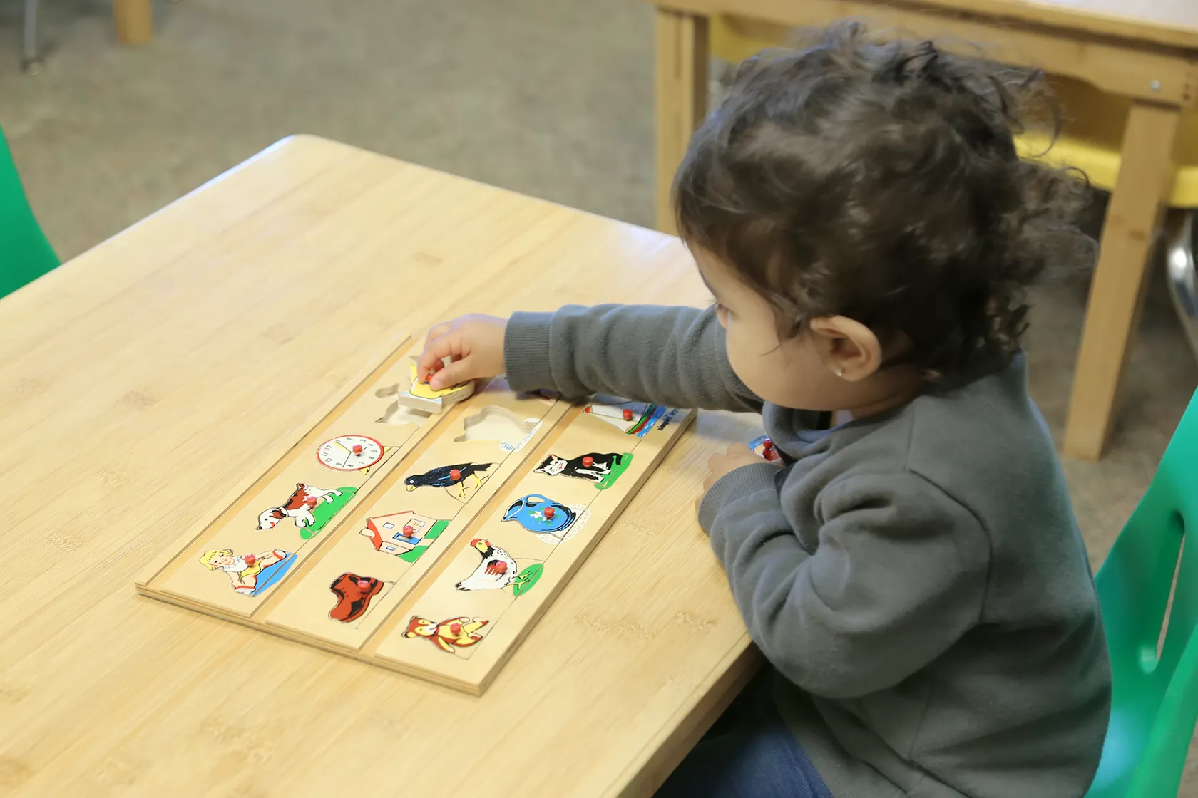 Montessori learning materials arranged on classroom shelves