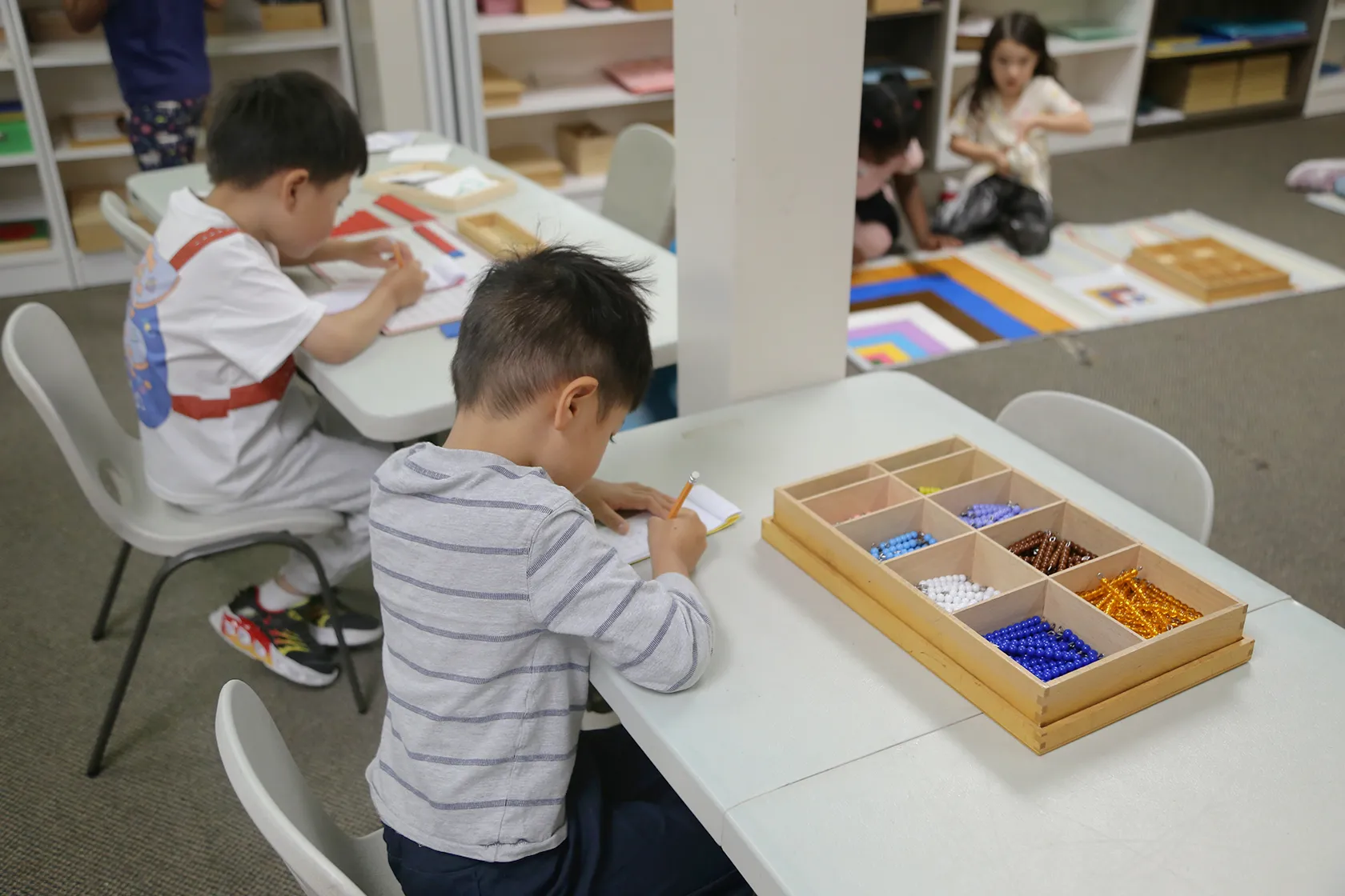 Child exploring a Montessori activity with bowls