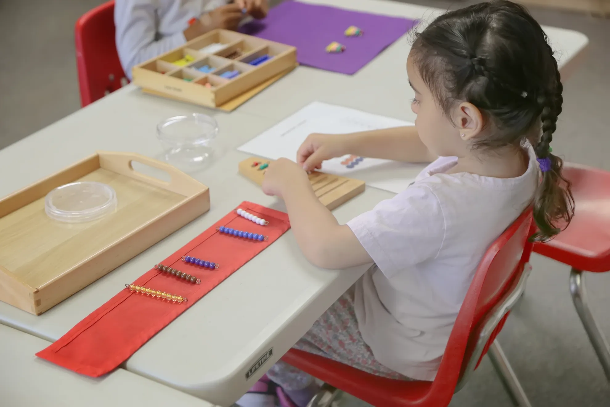 Casa children using Montessori materials